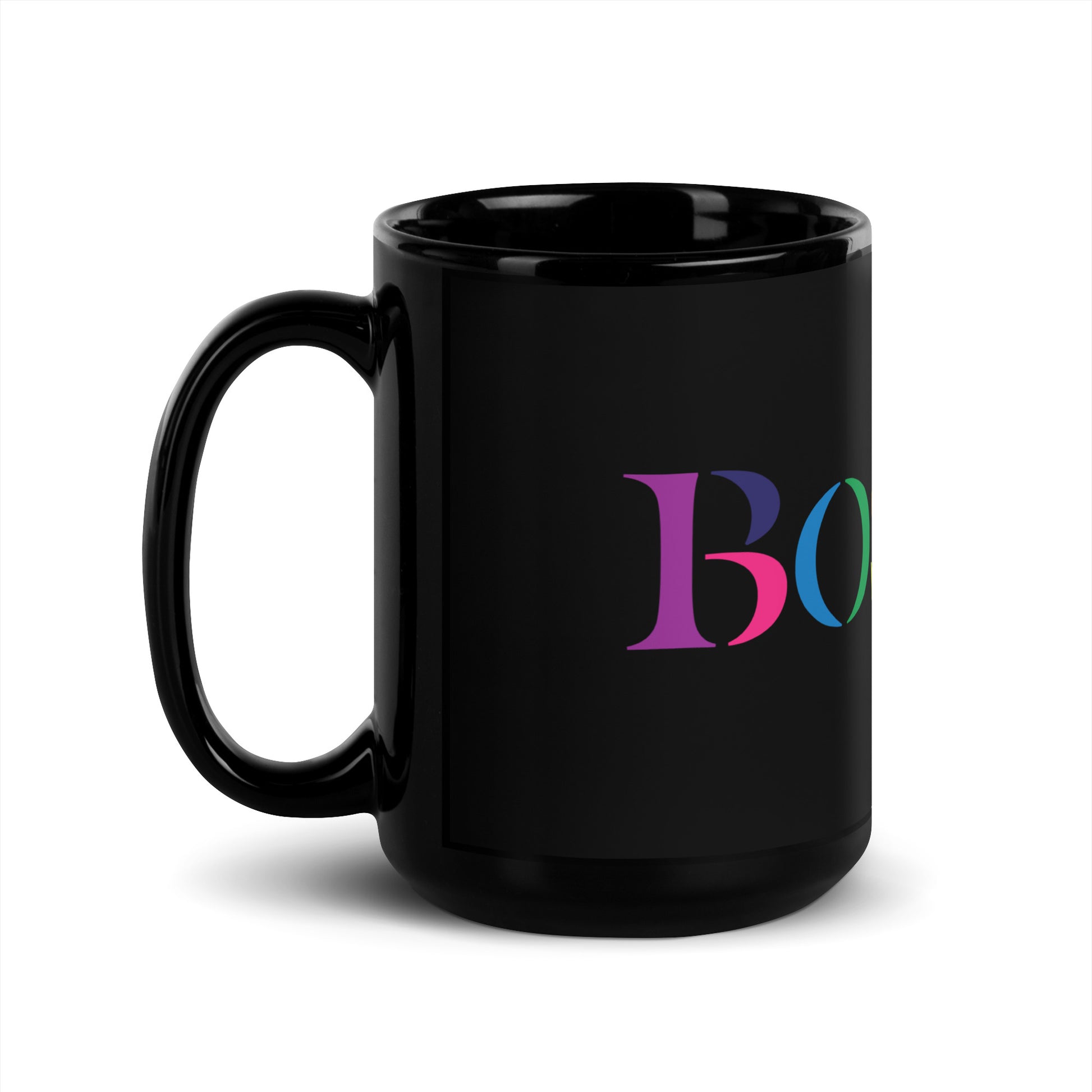 A glossy black ceramic mug against a white background. The mug features the word “BOSTON” in large serif letters, each filled with different bright colors including green, orange, purple, pink, and teal.