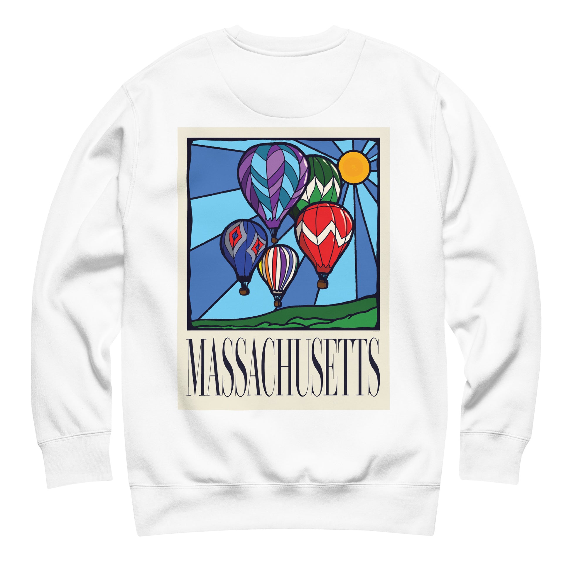 White colored Massachusetts sweatshirt laid flat, back view showing a large hand-drawn illustration of colorful hot air balloons and a bright sun over green hills, with the word ‘Massachusetts’ in serif font in Navy print below.
