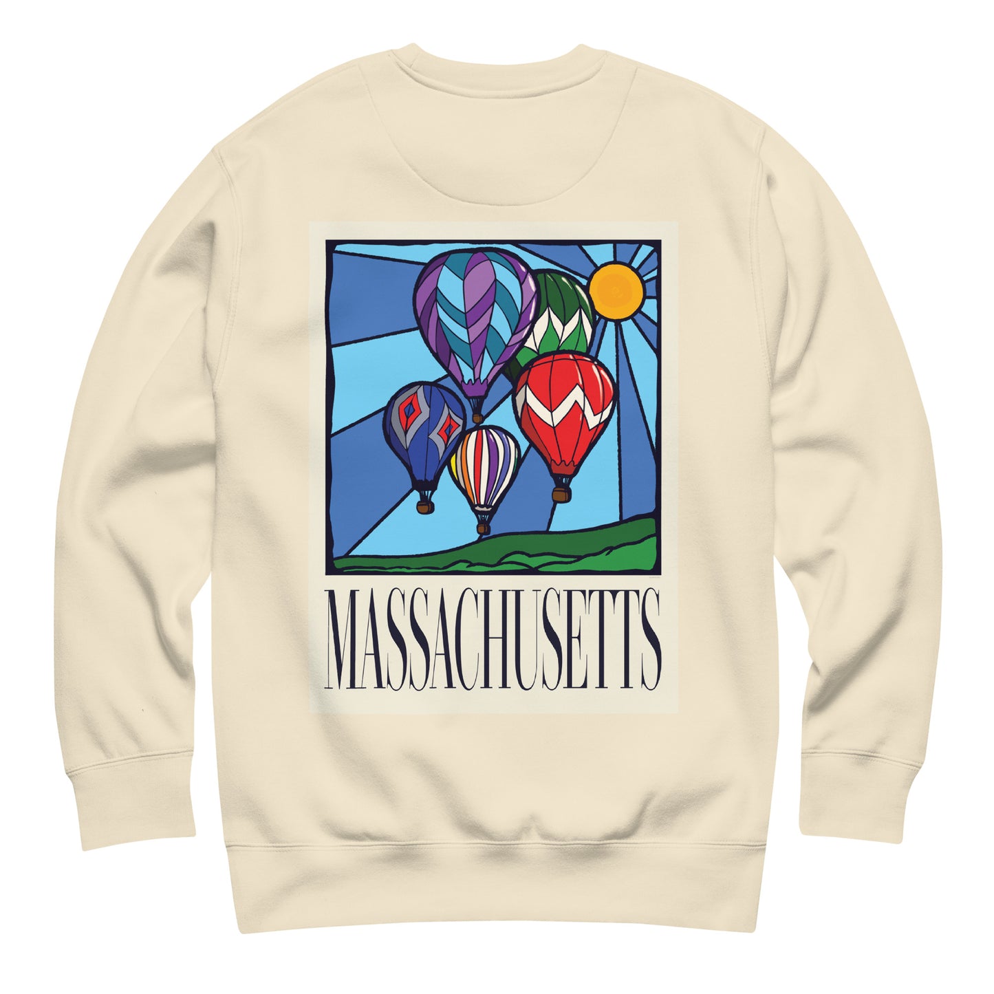 Bone colored Massachusetts sweatshirt laid flat, back view showing a large hand-drawn illustration of colorful hot air balloons and a bright sun over green hills, with the word ‘Massachusetts’ in serif font in Navy print below.