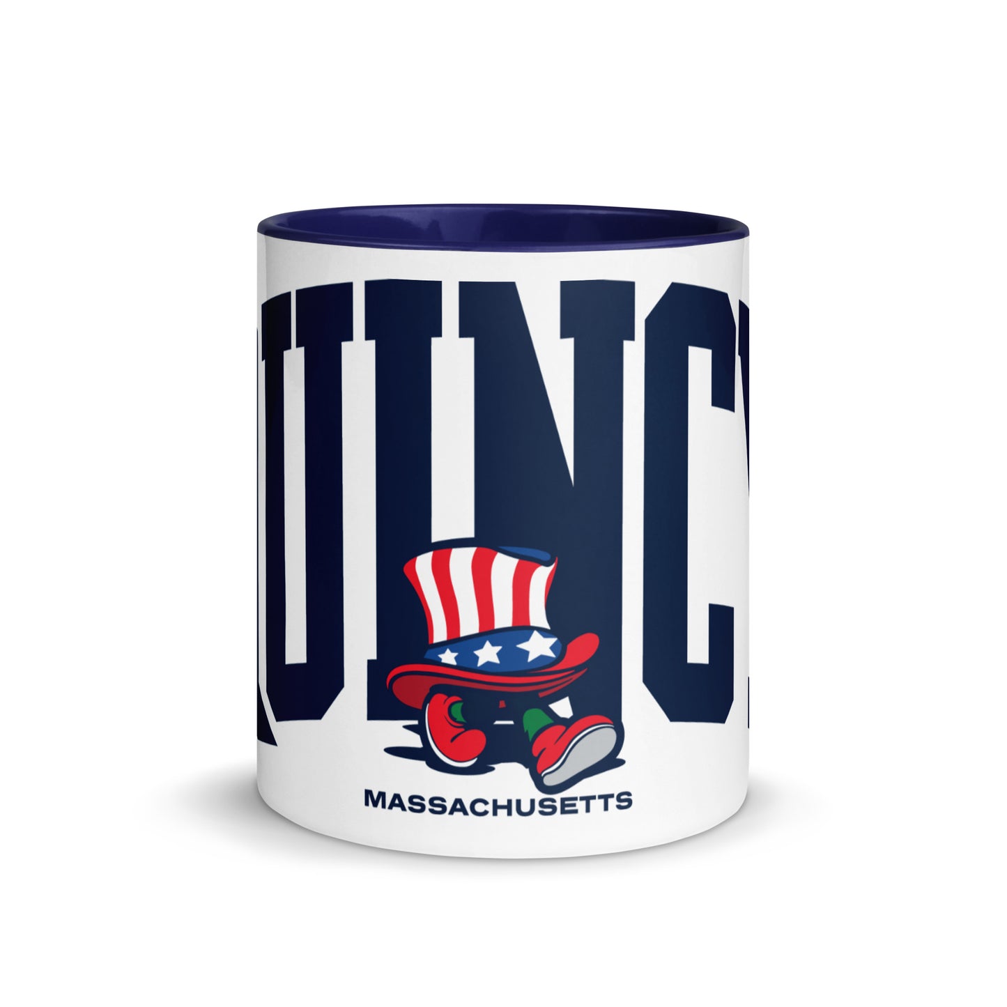A white ceramic mug with a Navy blue interior and handle, featuring bold navy letters spelling “QUINCY” across the front. In front of the text is a cartoon-style Walking President character wearing a red, white, and blue top hat and red shoes. The word “Massachusetts” appears below the artwork. The mug sits on a light wooden surface with a soft gray background.